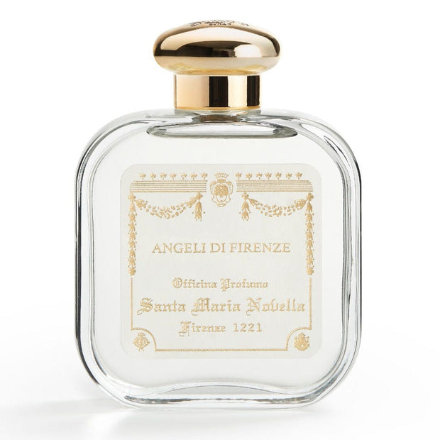 Perfume bottle with gold cap and decorative label on a white background